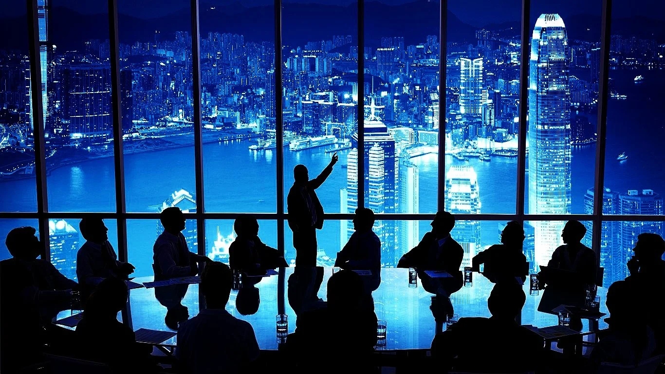 Silhouetted executives in a boardroom overlooking a skyline